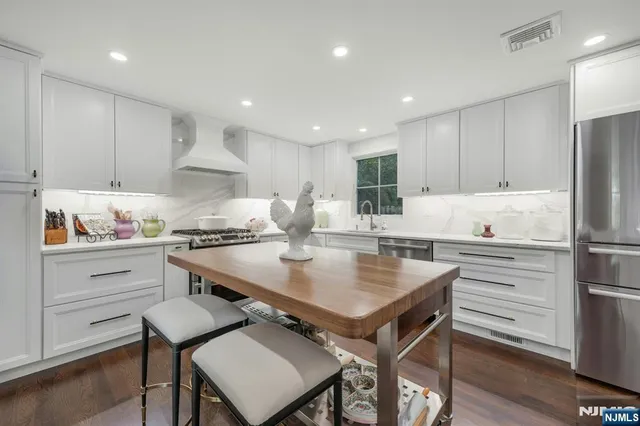 a front view of a residential houses with yard and green space