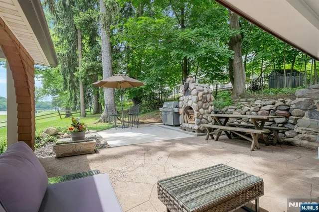 an aerial view of a house with a yard and lake