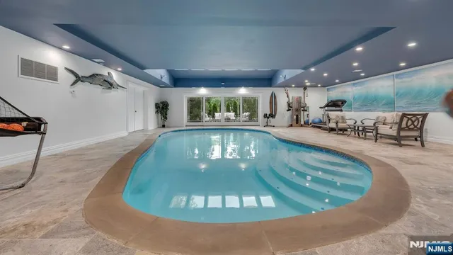 a large kitchen with stainless steel appliances granite countertop a large center island attached withe living room