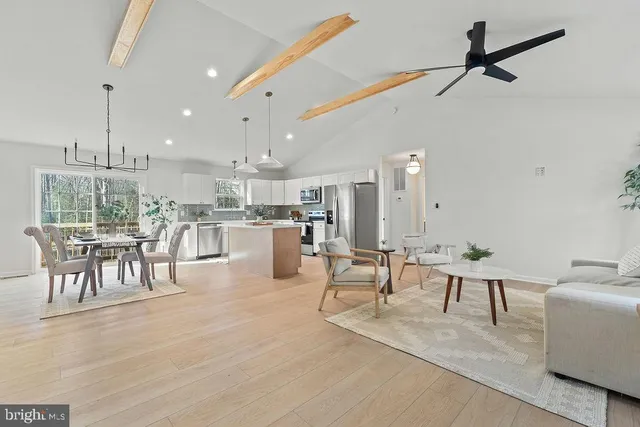 a living room with furniture and kitchen view