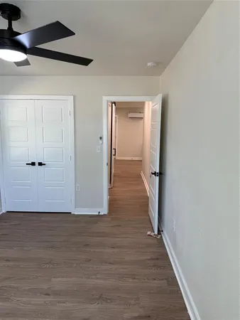 a view of hallway with wooden floor