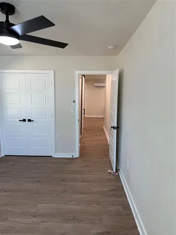 a view of hallway with wooden floor
