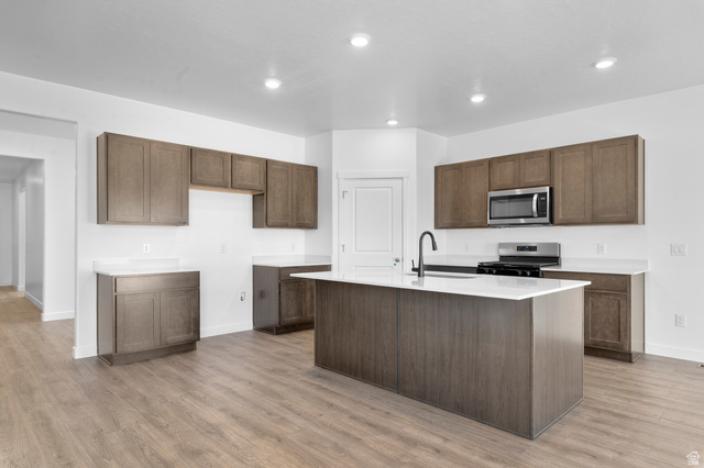 1338 West 2350 South, Unit 19 Perry, UT 84302 - Photo 2 of 14 Modern kitchen featuring wood-finish flooring, white countertops, and recessed lighting