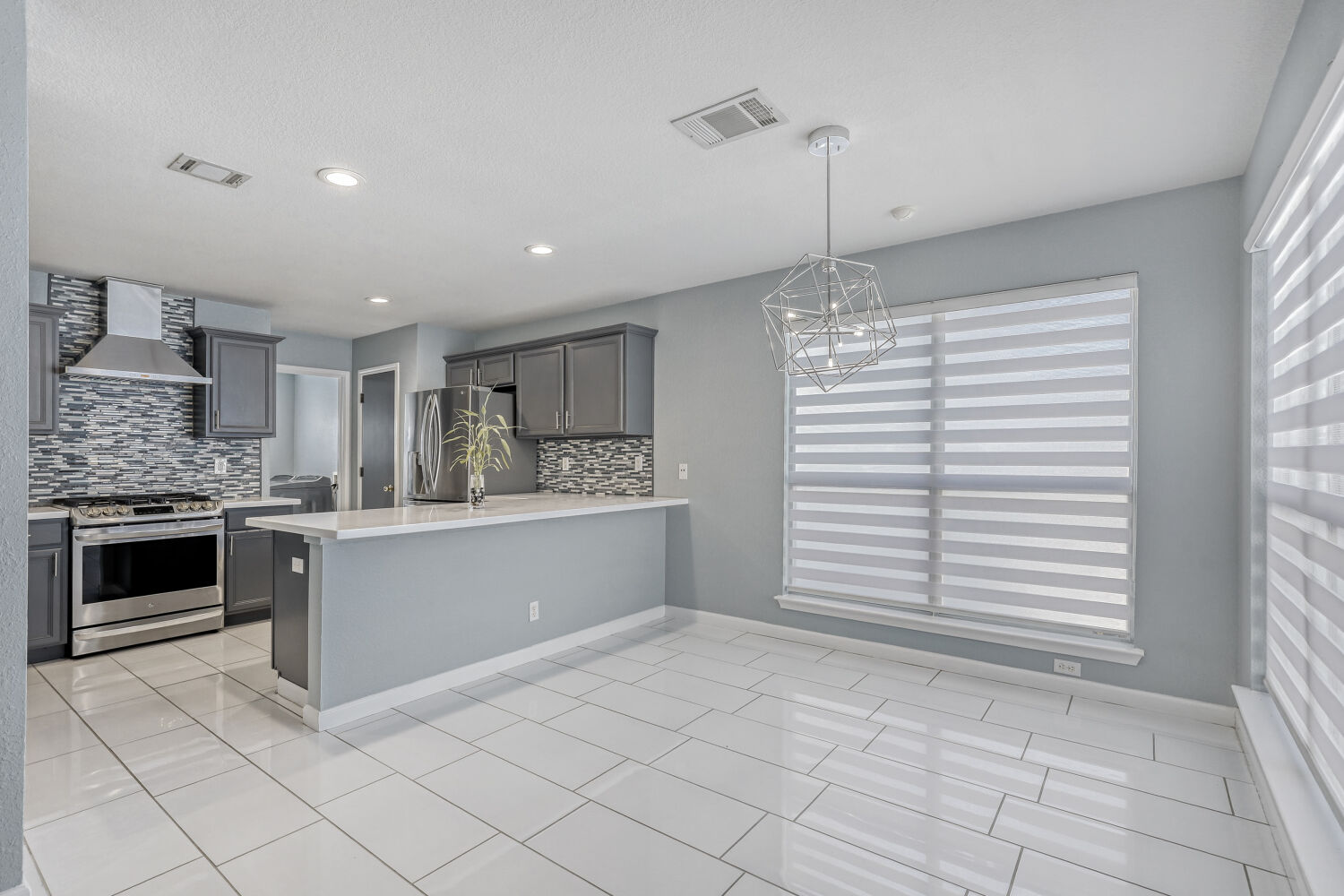 2529 Tandi Trail Round Rock, TX 78664 - Photo 12 of 32 a kitchen with granite countertop white cabinets and window