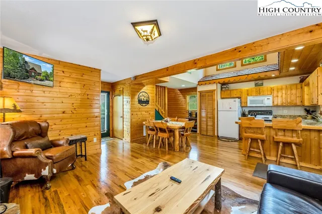 a living room with lots of furniture and a wooden floor