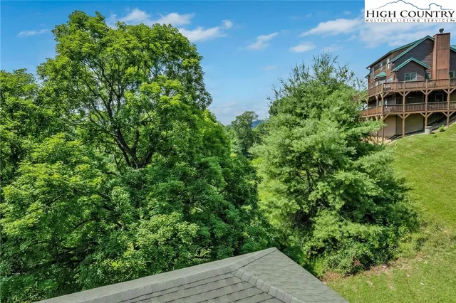 a view of yard with tree in front of it