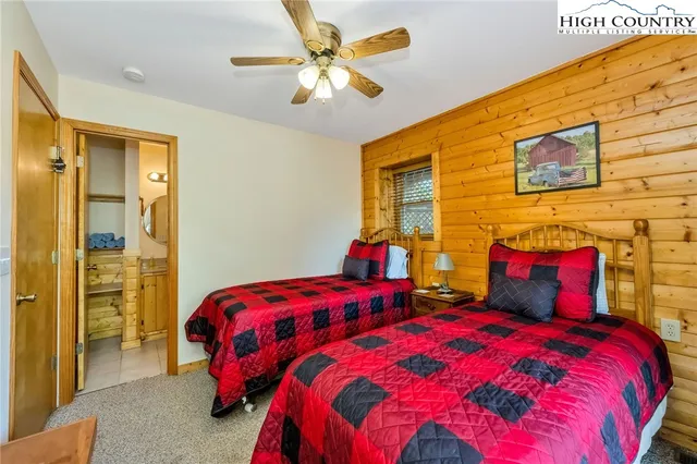 a bedroom with two beds and a chandelier