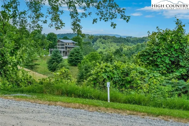 a view of a house with backyard and porch