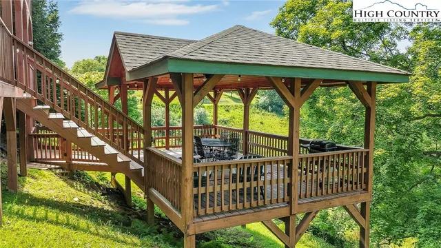a view of a porch with a floor to ceiling window and wooden fence