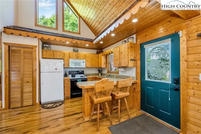 a dining hall with stainless steel appliances granite countertop a refrigerator and kitchen view