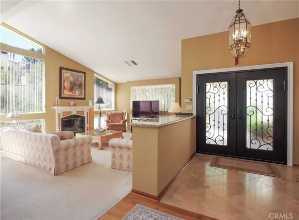 a kitchen with kitchen island granite countertop a sink cabinets and stainless steel appliances