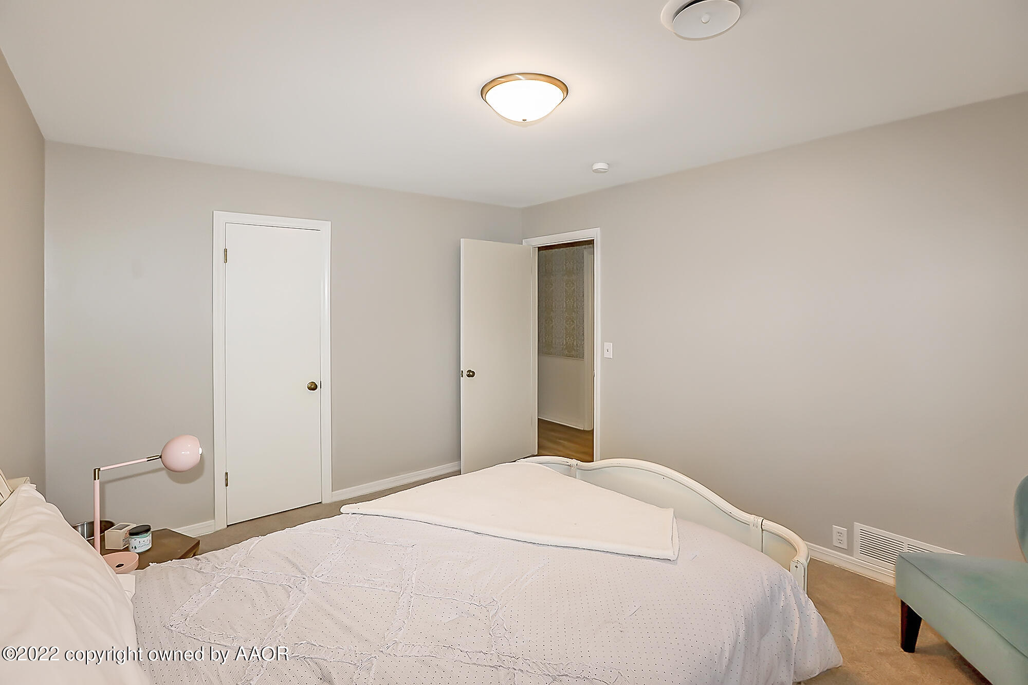 6303 Calumet Road Amarillo, TX 79106 - Photo 19 of 31 a bedroom with a bed and a lamp