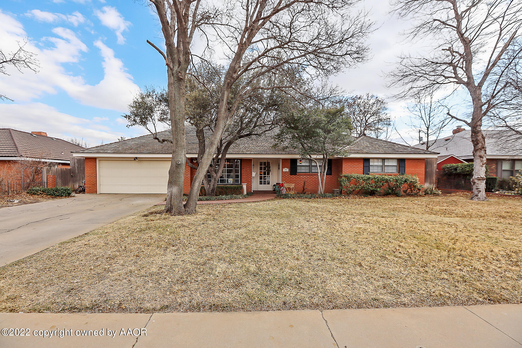 6303 Calumet Road Amarillo, TX 79106 - Photo 2 of 31 a front view of a house with a yard and garage