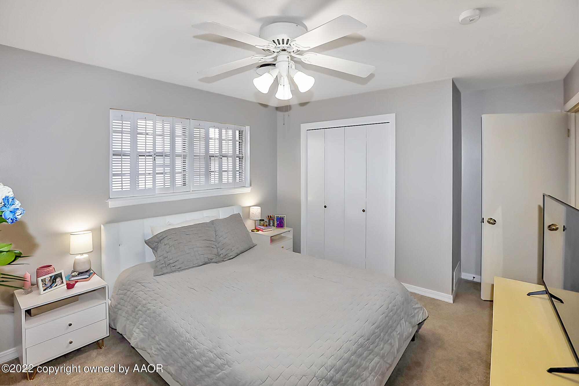 6303 Calumet Road Amarillo, TX 79106 - Photo 21 of 31 a bedroom with a bed and a chandelier