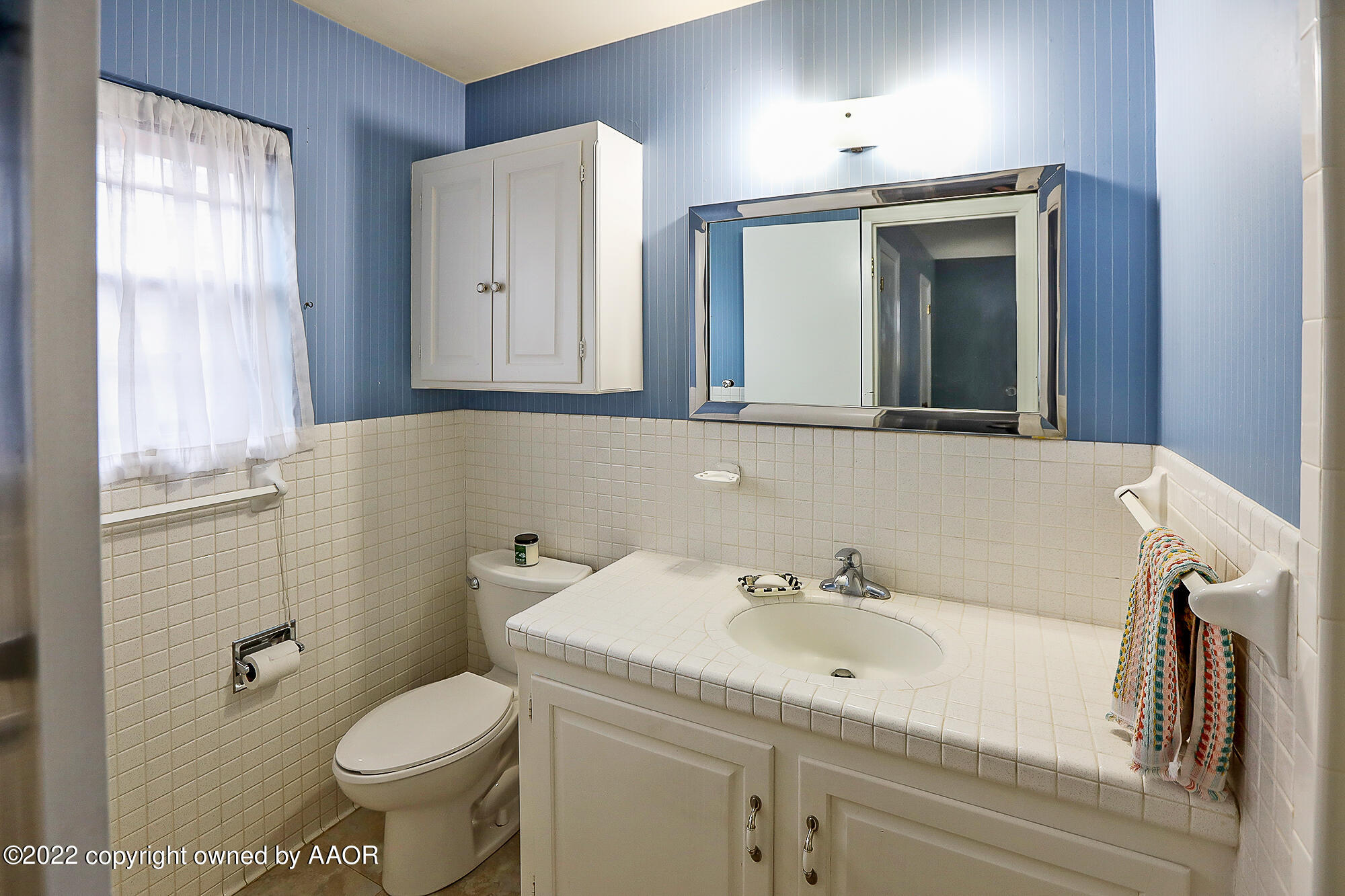 6303 Calumet Road Amarillo, TX 79106 - Photo 27 of 31 a bathroom with a sink a toilet and mirror