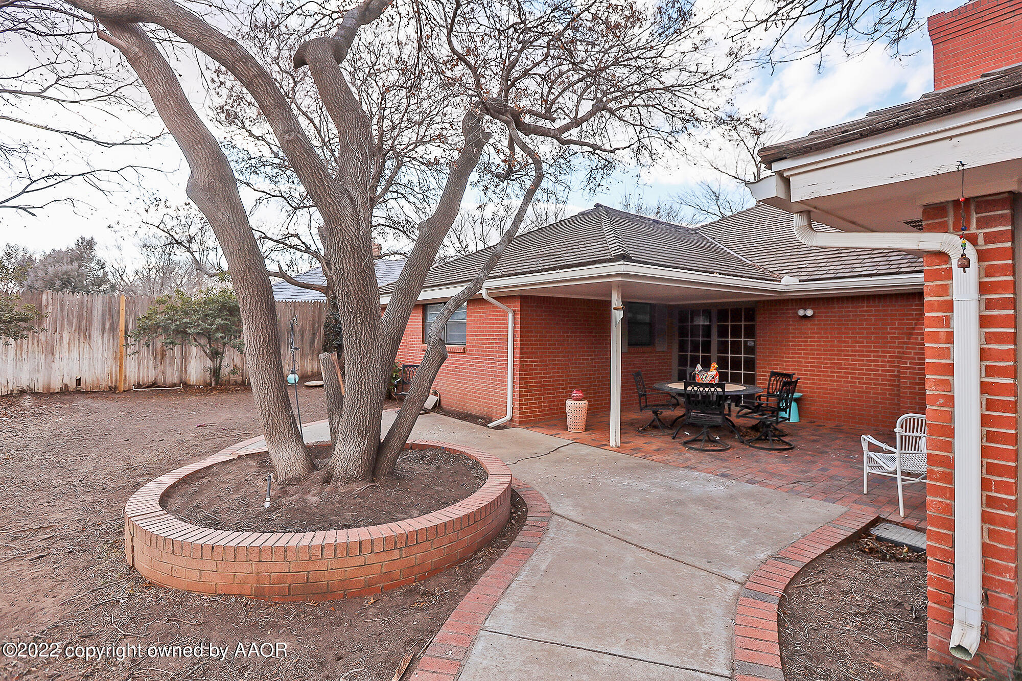 6303 Calumet Road Amarillo, TX 79106 - Photo 30 of 31 a front view of a house with garden fountain and sitting area