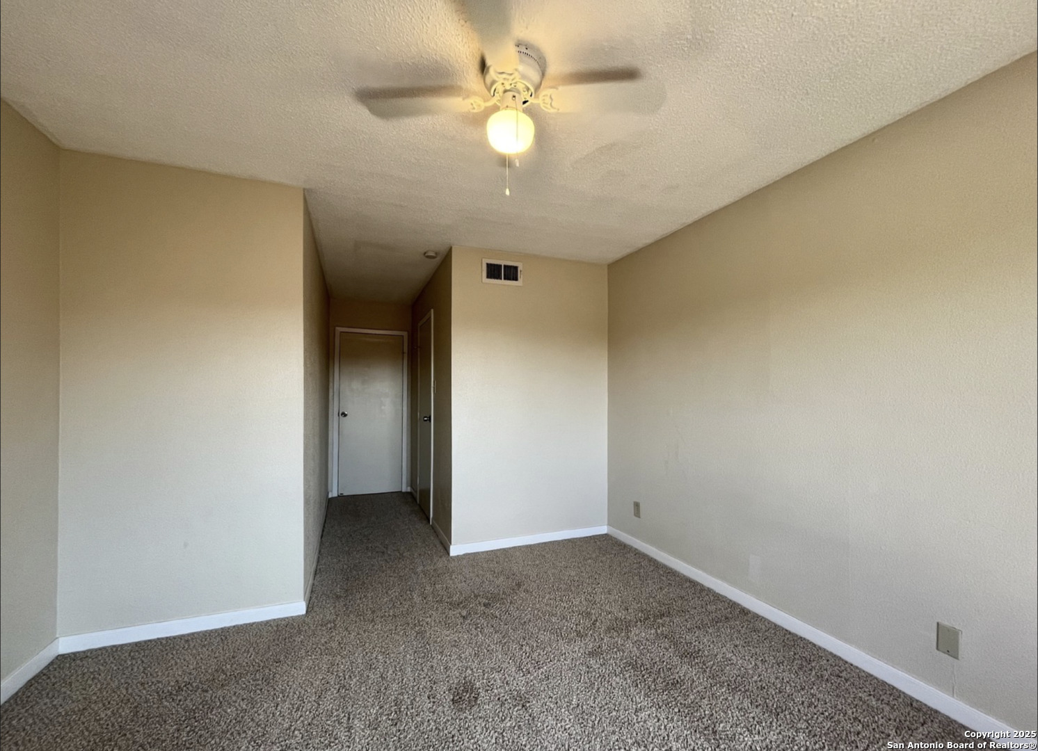 3243 Nacogdoches Road, Unit 404 San Antonio, TX 78217 - Photo 11 of 16 an empty room with a ceiling fan and a window