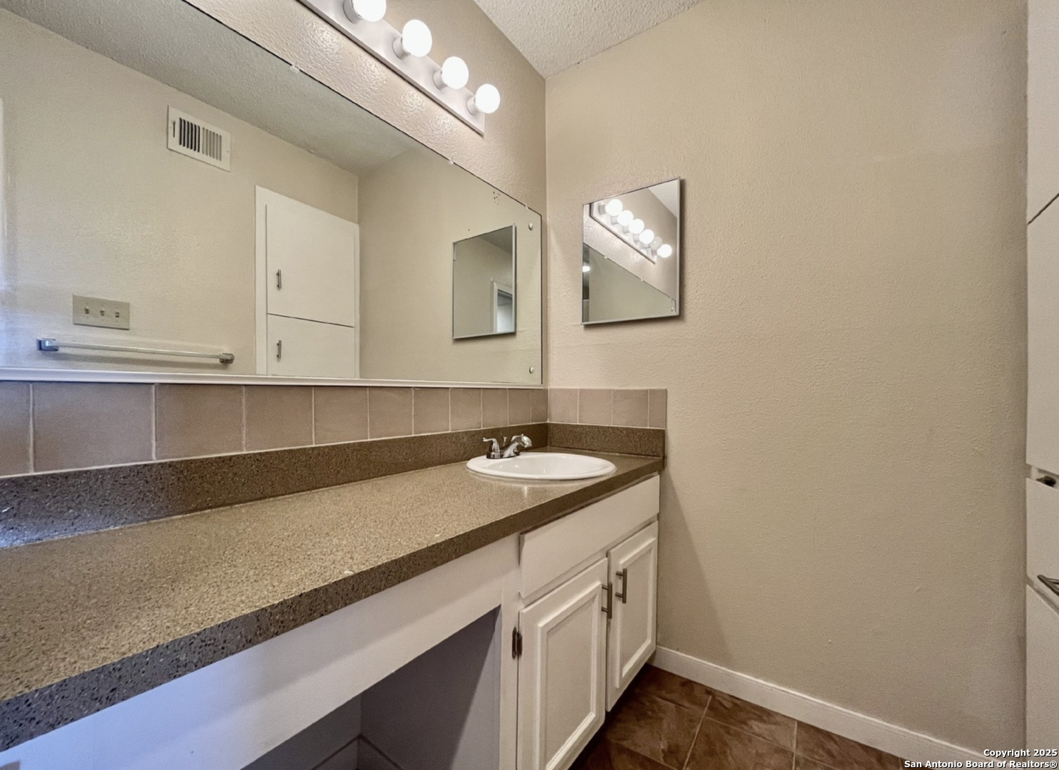 3243 Nacogdoches Road, Unit 404 San Antonio, TX 78217 - Photo 12 of 16 a bathroom with a sink and a mirror
