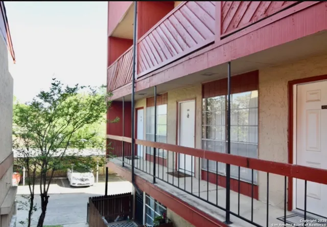 a view of a two chairs and table in the balcony