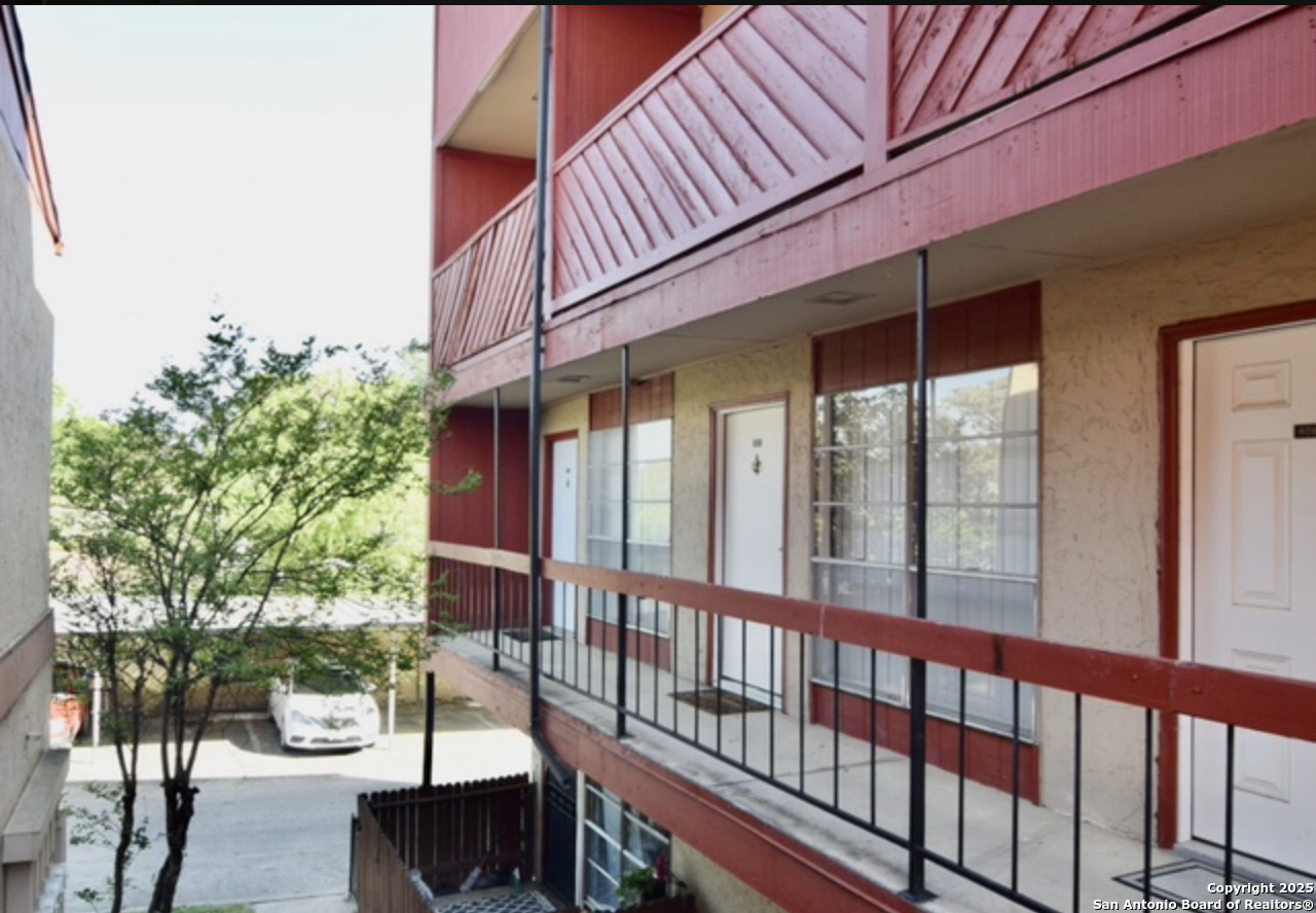 3243 Nacogdoches Road, Unit 404 San Antonio, TX 78217 - Photo 2 of 16 a view of a two chairs and table in the balcony