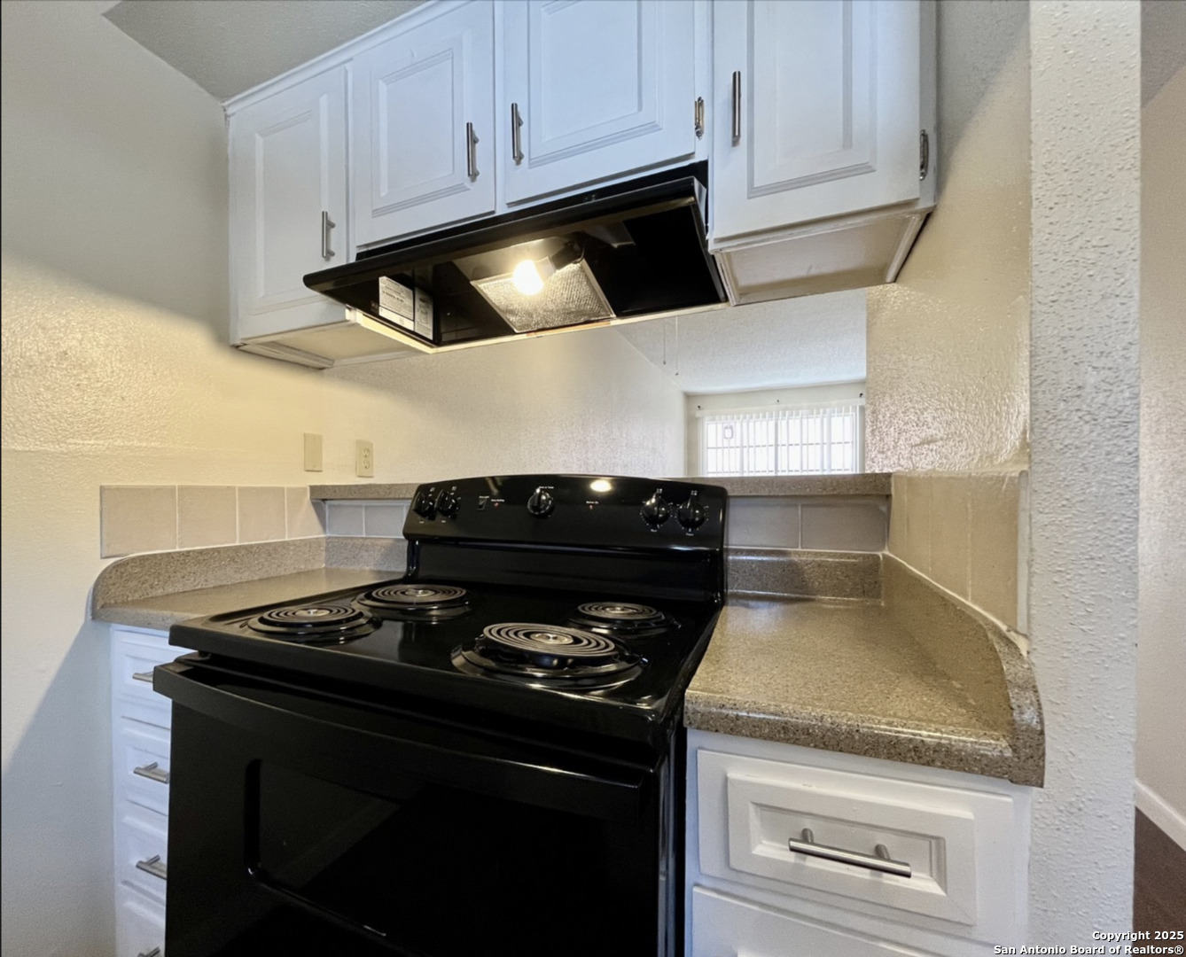 3243 Nacogdoches Road, Unit 404 San Antonio, TX 78217 - Photo 9 of 16 a stove top oven sitting inside of a kitchen
