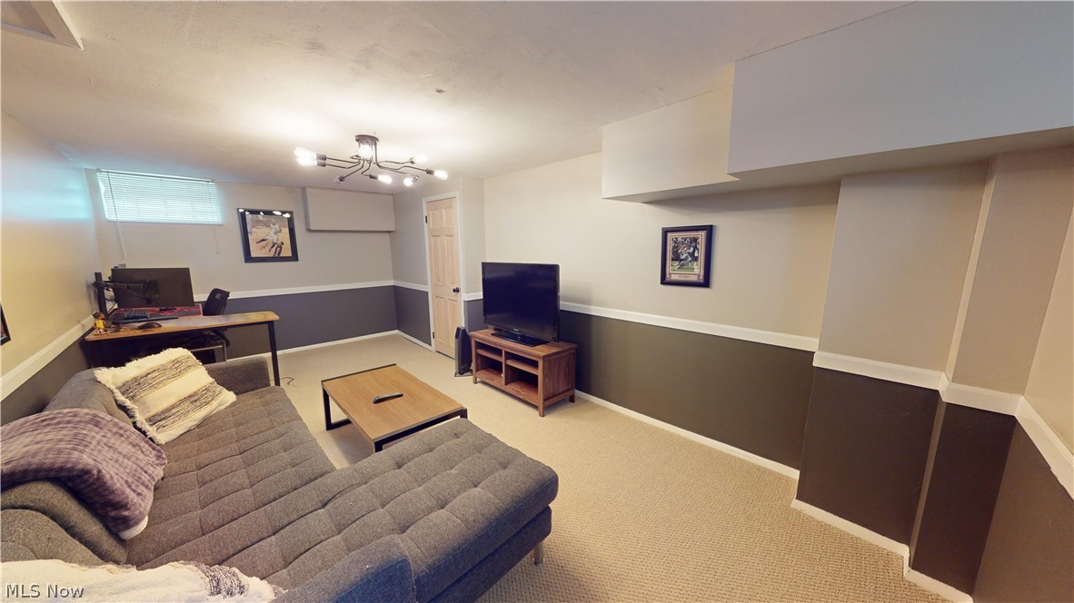 5175 Mayview Road Cleveland, OH 44124 - Photo 13 of 14 Carpeted living room with an inviting chandelier