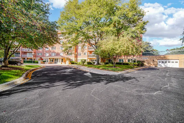 a view of a house with a big yard and large trees