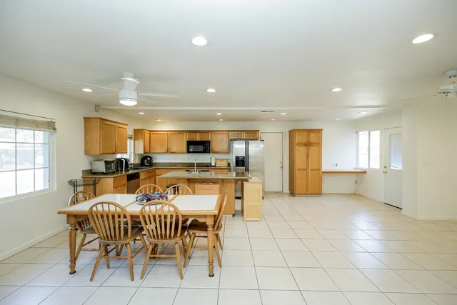 a dining room with furniture and kitchen view