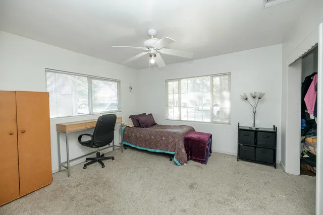 a livingroom with workspace and a window