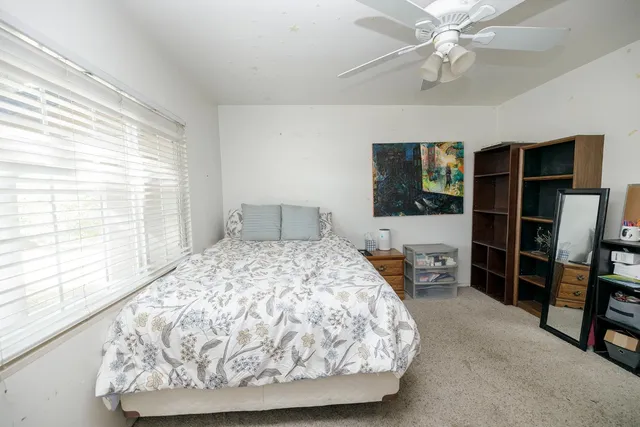a bedroom with a bed and a book shelf