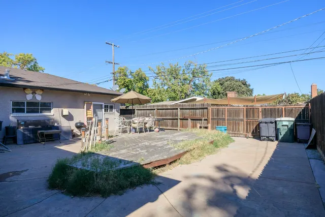 a view of a house with backyard porch and sitting area