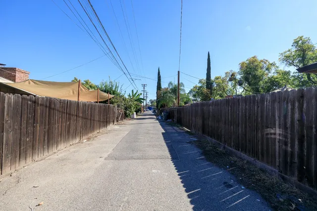 a view of a pathway with a wrought fence