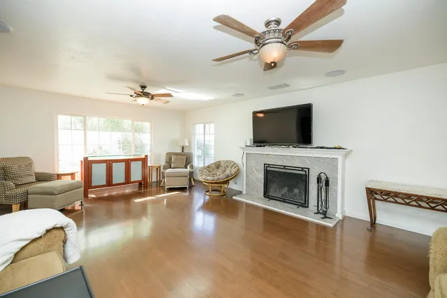 a living room with furniture a fireplace and a flat screen tv