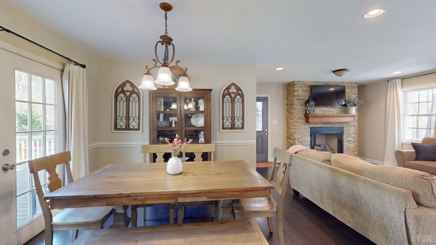 120 Ripley Drive Danville, VA 24540 - Photo 30 of 71 a living room with furniture chandelier and a flat screen tv