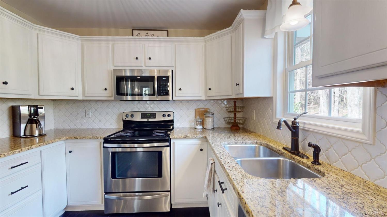 120 Ripley Drive Danville, VA 24540 - Photo 32 of 71 a kitchen with granite countertop a sink a stove and cabinets