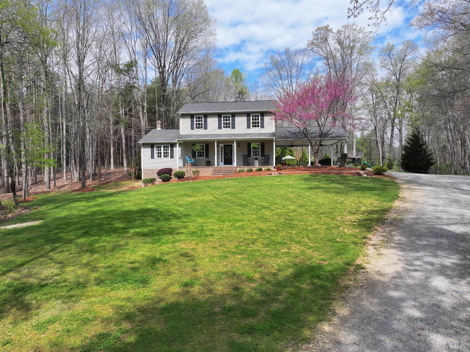 120 Ripley Drive Danville, VA 24540 - Photo 4 of 71 a view of a house next to a big yard and large trees