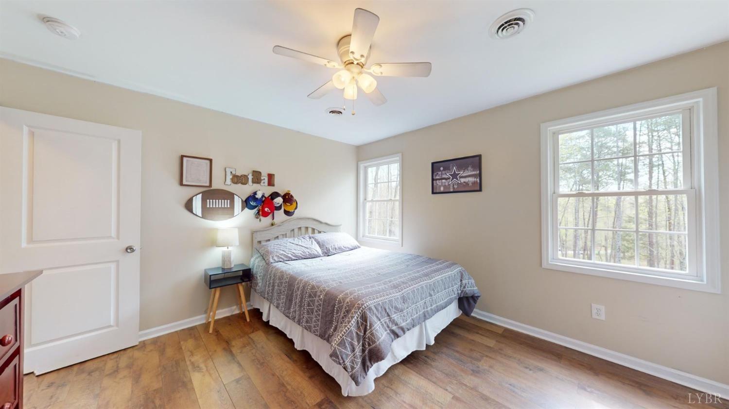 120 Ripley Drive Danville, VA 24540 - Photo 51 of 71 a bedroom with a bed and a chandelier