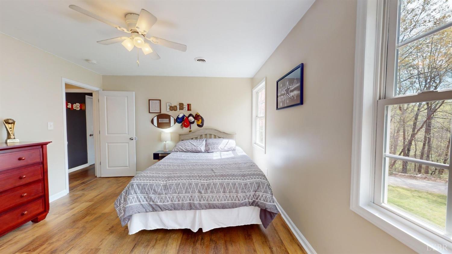 120 Ripley Drive Danville, VA 24540 - Photo 52 of 71 a bedroom with a bed and a chandelier