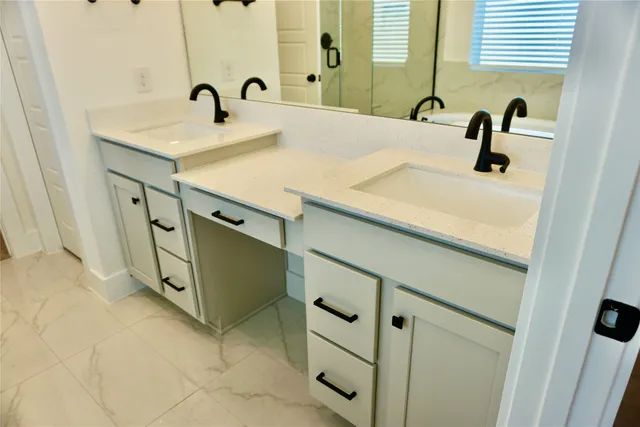 a bathroom with double vanity sink and mirror