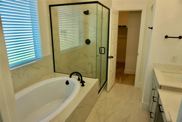 a bathroom with a bathtub and a shower