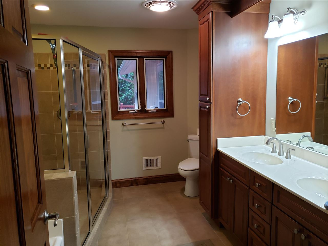 8529 Sawyer Drive Raleigh, NC 27613 - Photo 13 of 28 Spacious guest bathroom off hallway. Cherry cabinets, tile flooring, large shower and separate tub. One of 3 full baths all with tub and separate shower. Your guests will be appreciative. Bathroom