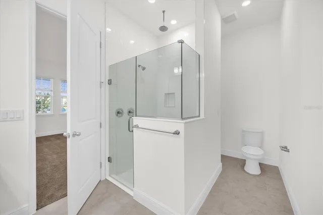 a bathroom with a shower and a toilet