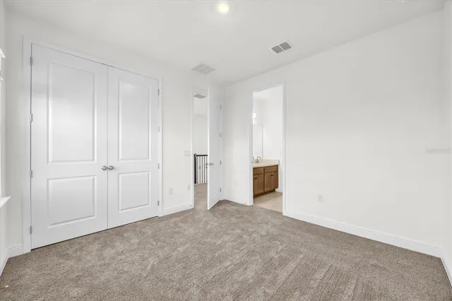 a view of an empty room and closet area