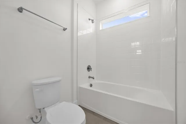 a bathroom with a toilet and a bathtub