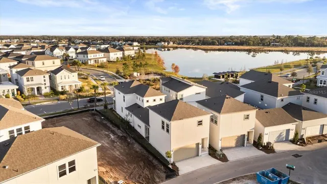 an aerial view of a residential building with outdoor space and ocean view