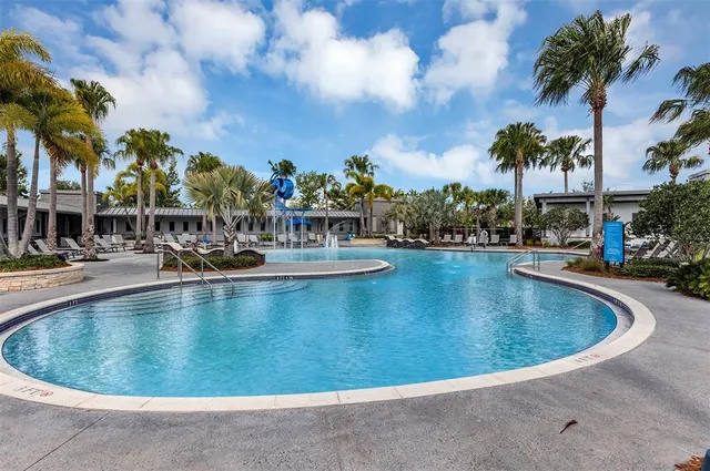 a view of a swimming pool with a table and chairs