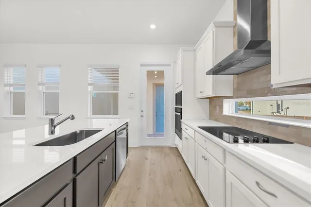 a kitchen with granite countertop a sink and cabinets