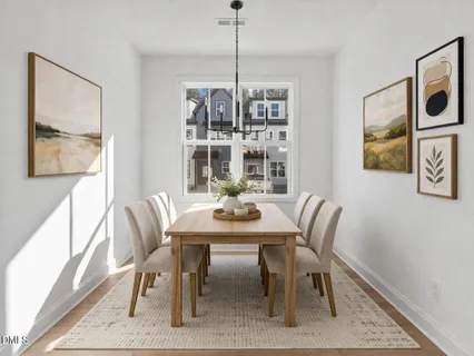 a view of a dining room with furniture window and wooden floor