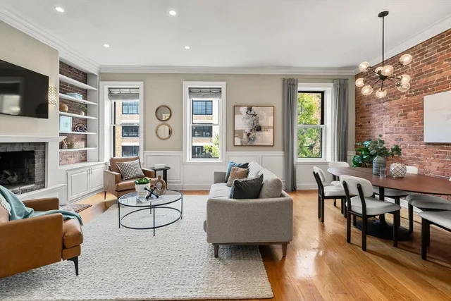 a living room with fireplace furniture and a flat screen tv