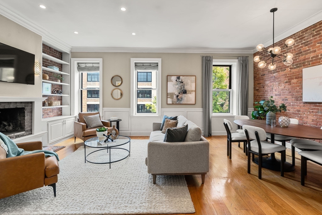 82 Berkeley Street, Unit 5 Boston, MA 02116 - Photo 1 of 32 a living room with fireplace furniture and a flat screen tv